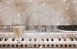 Artwork in vintage style, champagne glass, pianoforte/ snow effect photo