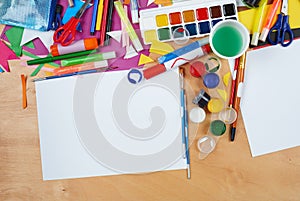 Artwork workplace with creative accessories, art tools for painting and drawing