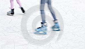Arty blurry two teenage girl ice skating legs