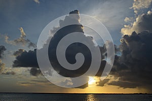 Aruba sunset with billowing clouds, light, and sea