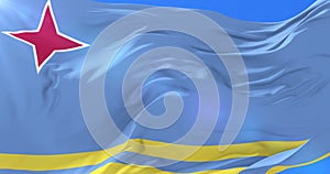 Aruban flag waving at wind in slow with blue sky, loop