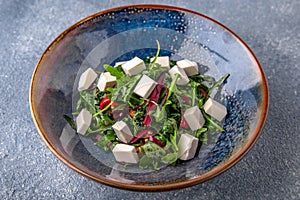 Arugula salad, cherry tomatoes, beets, olives and feta cheese. Natural delicious food. Greek cuisine menu.