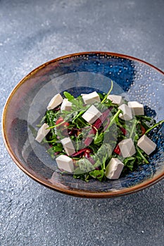 Arugula salad, cherry tomatoes, beets, olives and feta cheese. Natural delicious food. Greek cuisine menu.