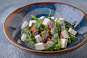 Arugula salad, cherry tomatoes, beets, olives and feta cheese. Natural delicious food. Greek cuisine menu.