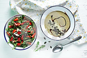 Arugula salad with strawberries and eggplant creamy soup