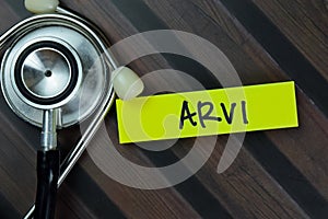 ARVI write on sticky notes isolated on Wooden Table. Medical concept