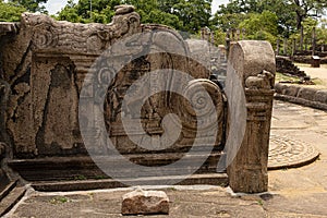 Arvings of gods flank the staircases inthe ruins at Polonuwara