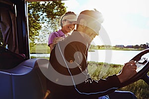 Almost as good as my handicap, honey. a man writing on a score card while out for a game of golf with his wife.