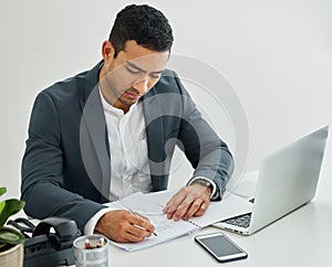 As for now Ive a different weapon. a businessman doing paperwork at his desk in a modern office.