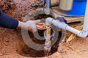 As part of repair work, technician plumber uses specialized scissors to cut a plastic PVC pipe