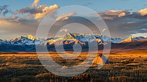 As the sun sets behind the distant mountains a solitary tent basks in the gentle light promising a night of restful photo