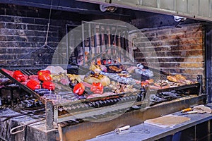 Asado parrillada grill bbq in famous old town Montevideo port market, mercado del puerto, Montevideo, Uruguay