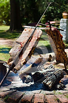 Asado, traditional barbecue dish in Argentina, roasted meat cooked on a crossed vertical grills