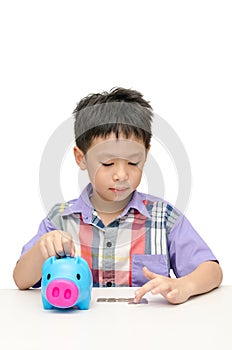 Asain boy counting coins from piggybank