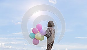 Asain girl holding balloon with blue sky background