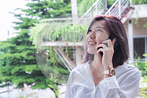 Asain girl`s smiling and using smart phone , happy time and taking mobile telephone