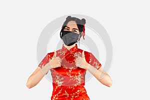 Asain woman in red cheongsam costume wear a black mask with thumbs up. Chinese new year concept style