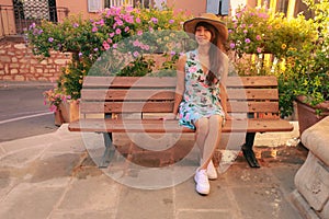 Asain woman sitting on a bench