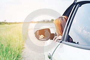 Asain woman traveler with car on Beautiful road