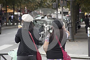 Asain women mother and daughter waiting for crossing traffic road