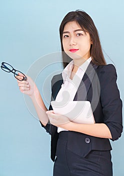 Asain women in suit standing using her digital tablet