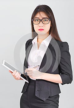 Asain women in suit standing using her digital tablet computer