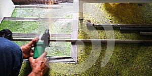 Worker using the machine is hand steel shears