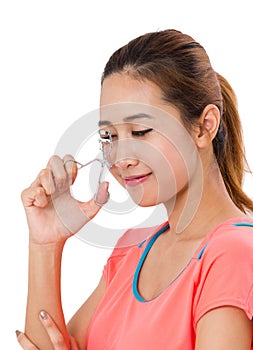 Asain Young Woman Using Eyelash Curler.