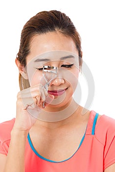 Asain Young Woman Using Eyelash Curler.