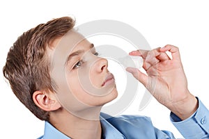 Asal spray drops in hand of ill young boy, closeup on white photo