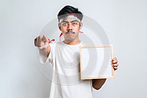 Asan man holding blank board pointing with finger to the camera