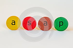 Asap is an abbreviation and stands for as soon as possible. The letters stand on colorful toy wooden building blocks