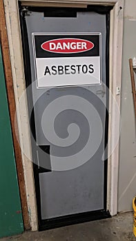 Asbestos warning sign on door