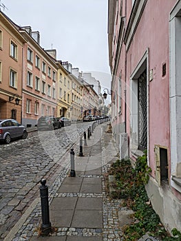 Ascend the stone path, hemmed in by towering buildings