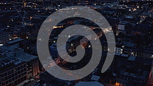 Ascending footage of evening city. Blocks of buildings in urban district. Night scene. Limerick, Ireland