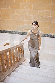 Ascending with poise. Portrait of an elegantly dressed young woman standing on a staircase.