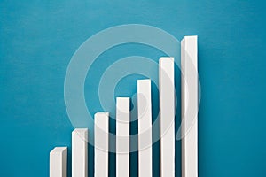 Ascending white bars on blue background symbolize growth and focus with uniform texture for clarity