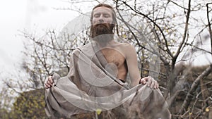 Ascetic yogi meditating in mountains
