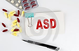 ASD text written in a card with pills. Medical concept