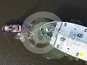 A tugboat assisting a bulkcarrier photo