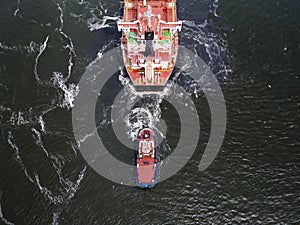 A tugboat assisting a bulkcarrier photo