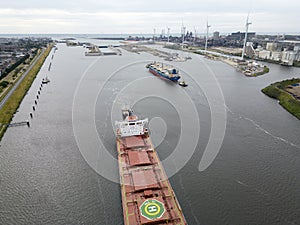 A tugboat assisting a bulkcarrier photo