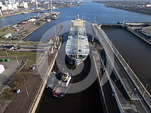 A tugboat assisting a bulkcarrier photo