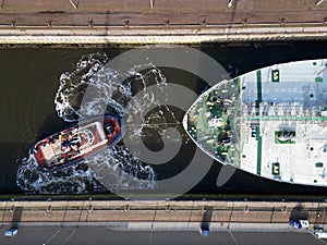 A tugboat assisting a bulkcarrier photo