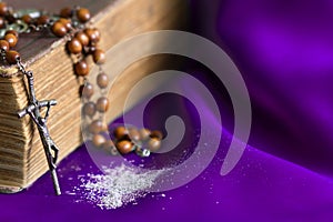 Ash Wednesday religion concept on violet fabric background with rosary