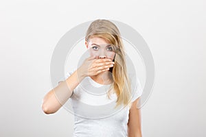 Ashamed woman having hand on mouth