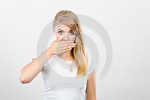 Ashamed woman having hand on mouth