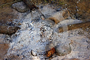 Ashes on ground after burn out along the night