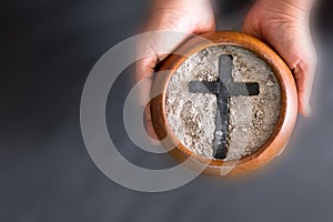 Ashes in hand are prepared for Christian festival of apostles. dust symbol of religion, sacrifice, redemption, Jesus Christ, ash