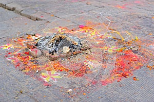 Ashes Left After Worship (Puja) with Flowers, Colour Powder and Drawings on the Ground photo